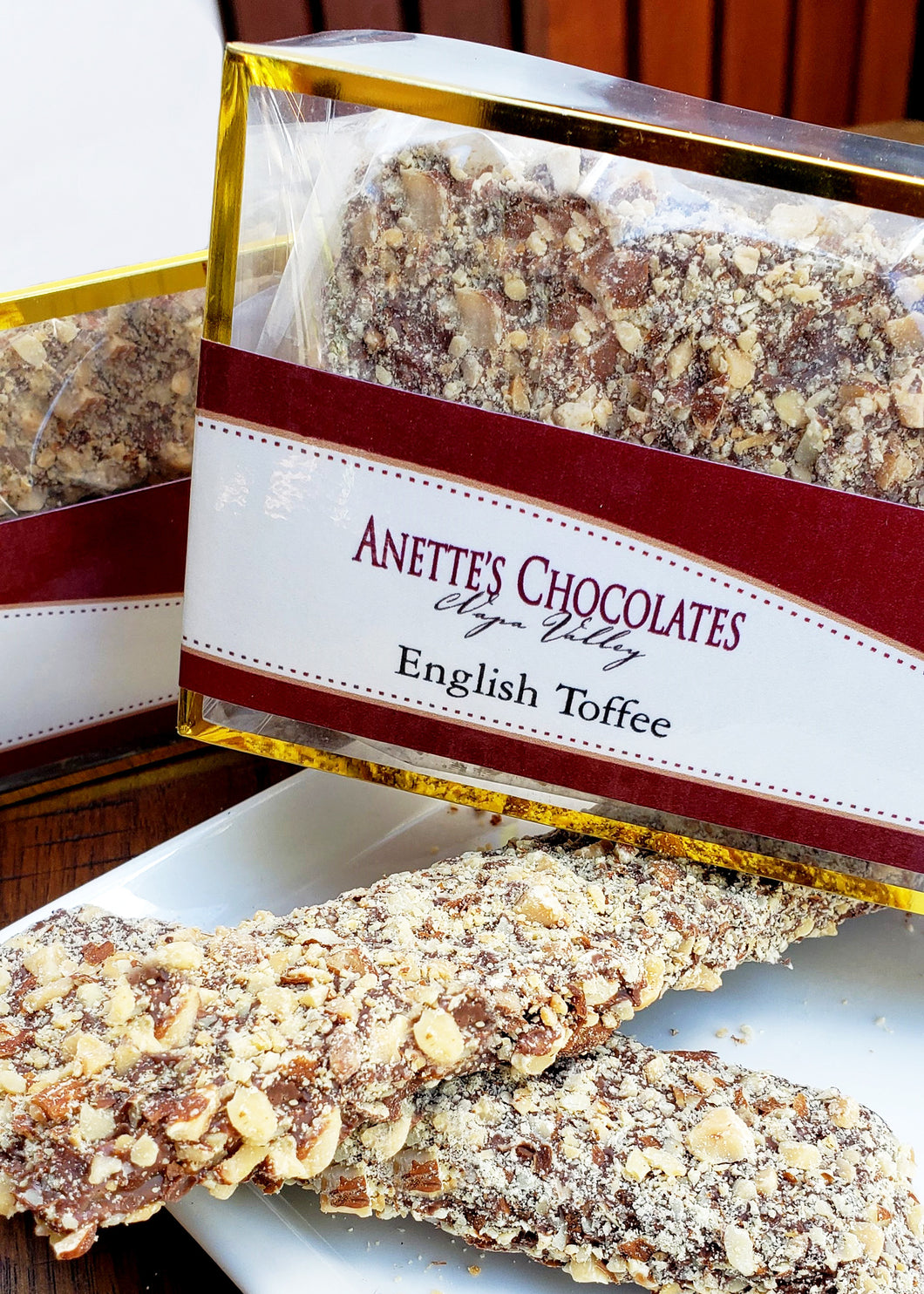 box of English toffee with pieces on a plate